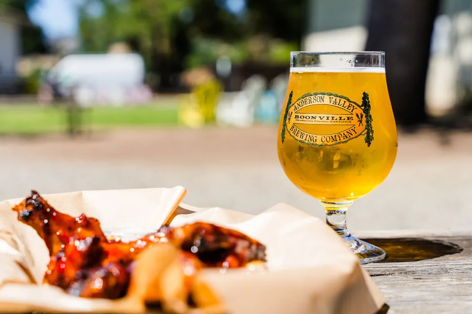 BBQ wings and a fresh pour in an Anderson Valley Brewing Company glass on the taproom patio in Boonville