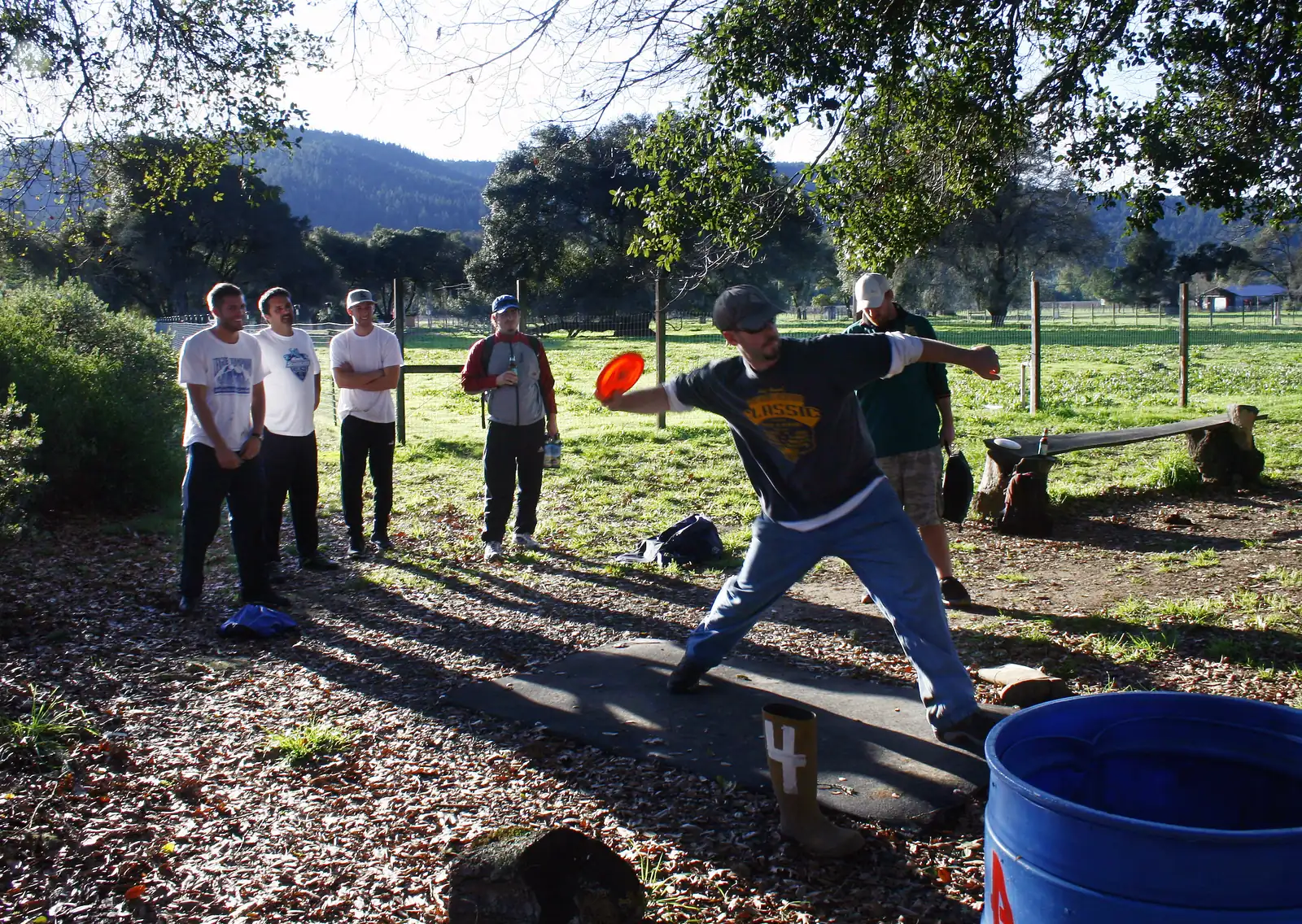 Players teeing off at hole 1 of the Anderson Valley Brewing disc golf course, marked by its famous boot